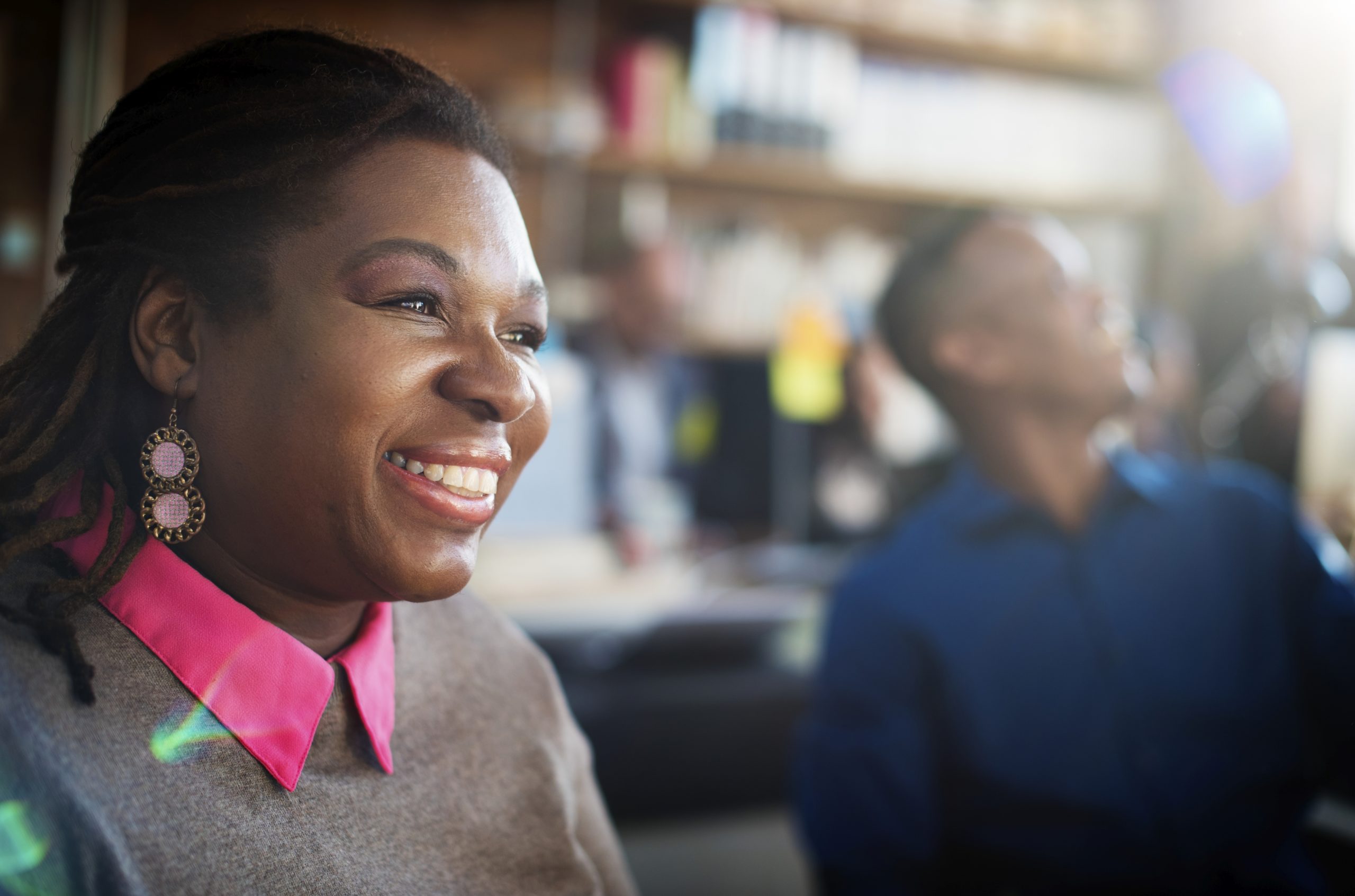Closeup of black woman smiling cheerful at workplace