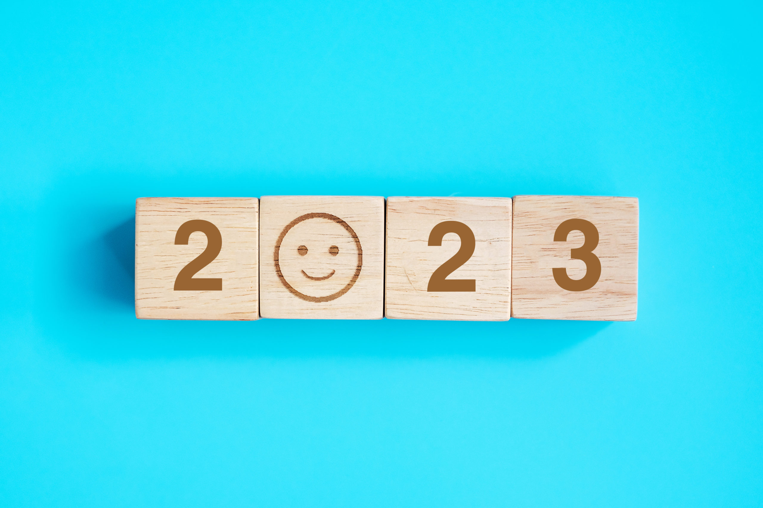 Smile face block with 2023 text on blue background 2023 trends